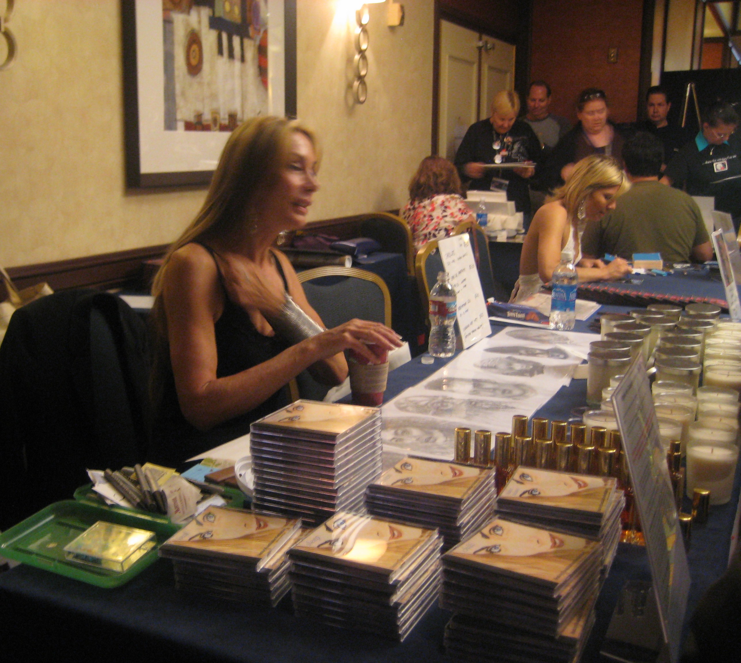 Virgina Hey sells her meditiation CDs while Gigi Edgley sells items a little further down the table.